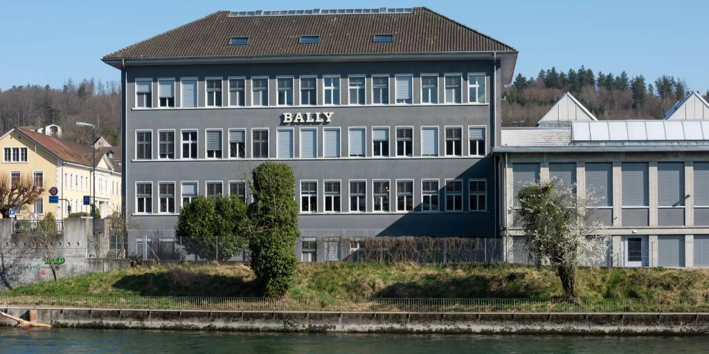 A grey four-storey factory building on the bank of the Aare with BALLY in white letters across the facade.