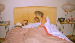 Me (on the left), Shauna (the baby), and Nana. My guess is late 1955. This isn't the best photograph -- no faces showing. I've included it anyway because I thought the bedside table is interesting. I love the old dial telephone, the 1950's shoji lamps. But my favourite thing is the bottle of lager and cigarettes. I never remember my grandmother drinking --- butlarger!How images can be shattered through the magnification power of Adobe Photoshop.