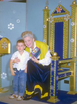 I have no idea who this lady is, why she's sitting on a throne, and why I look so unhappy. The photo has a Christmas look --- perhaps sending letters to Santa? But the lady is a tad scary.