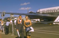 I can only guess at the date of this photograph -- late 1950's or early 1960's. The old Honolulu Airport terminal is behind the PanAm airplane. I love the PanAm attendants doing things at the gate itself. No air bridges. My father with Nana: not sure who's going where.