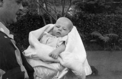 Craig Being Held by Father John Walsh, 1949