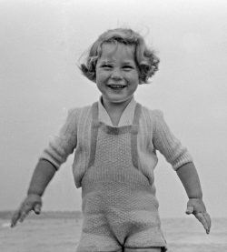 In a knitted wool bathing suit.